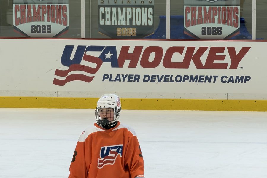 Cameron Cadena on the ice in front of the USA Hockey Player Development Camp boards in Oxford, Ohio